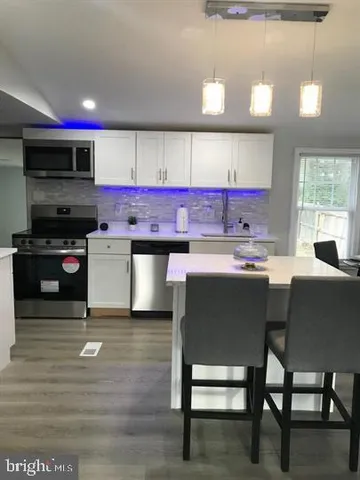 a kitchen with a sink cabinets and window