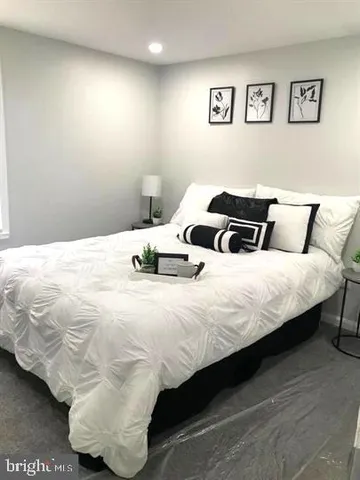 a bedroom with bed and a night stand