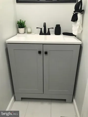 a bathroom with a sink and mirror