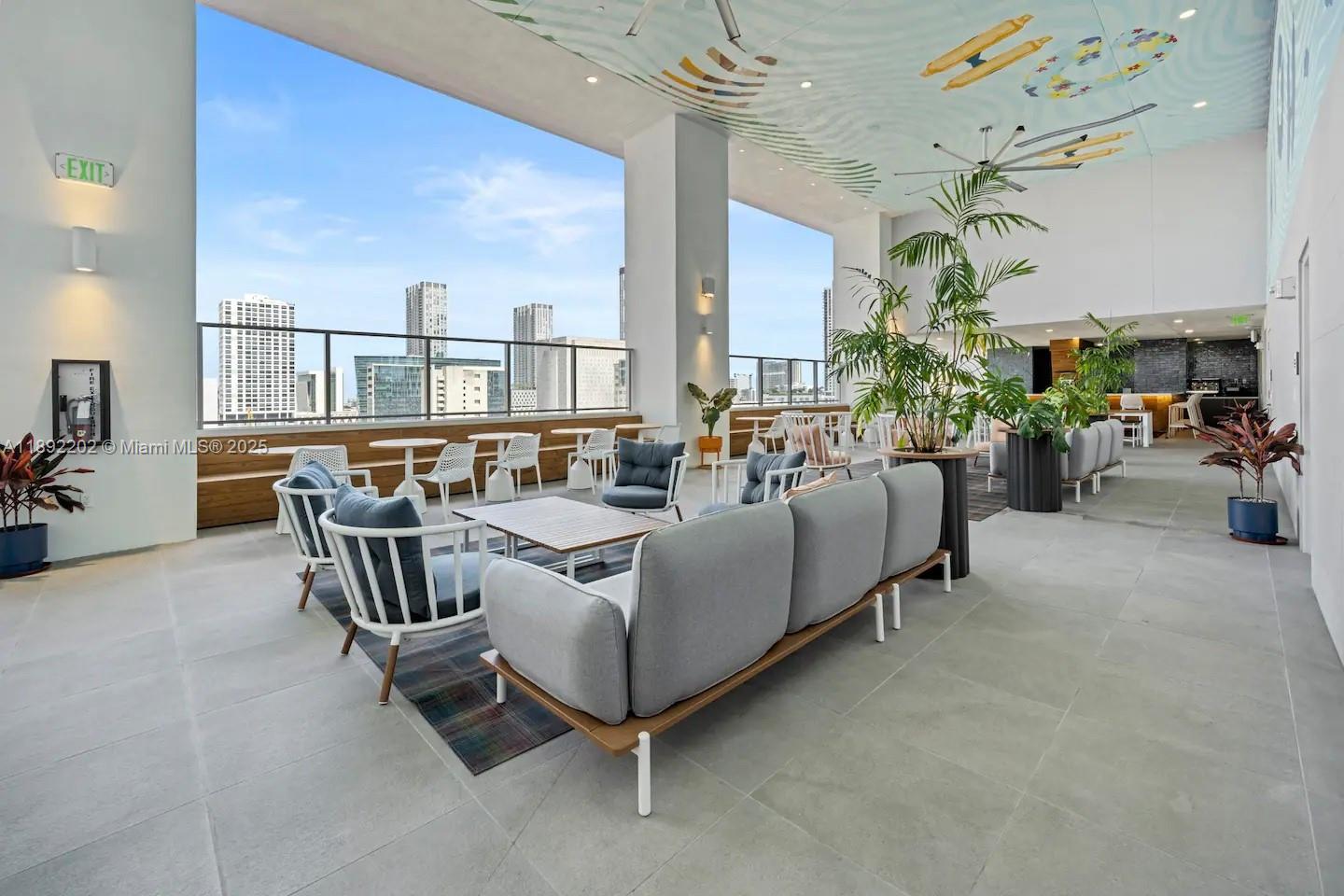 227 Northeast 2nd Street, Unit 2508 Miami, FL 33132 - Photo 25 of 28 a living room with furniture and a chandelier