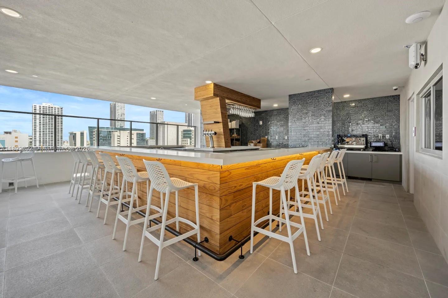 227 Northeast 2nd Street, Unit 2508 Miami, FL 33132 - Photo 26 of 28 a dining area with stainless steel appliances kitchen island granite countertop a dining table chairs and a refrigerator