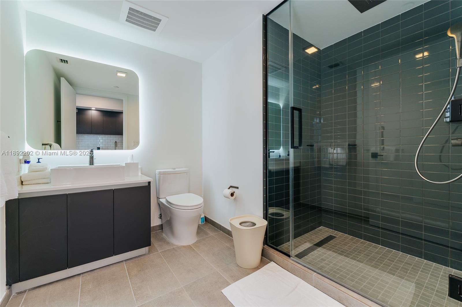 227 Northeast 2nd Street, Unit 2508 Miami, FL 33132 - Photo 6 of 28 a bathroom with a double vanity sink mirror and toilet