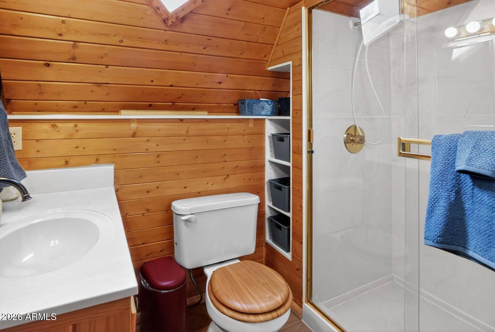 8884 Tonto Rim Drive Pine, AZ 85544 - Photo 32 of 43 a white toilet sitting next to a bathroom sink
