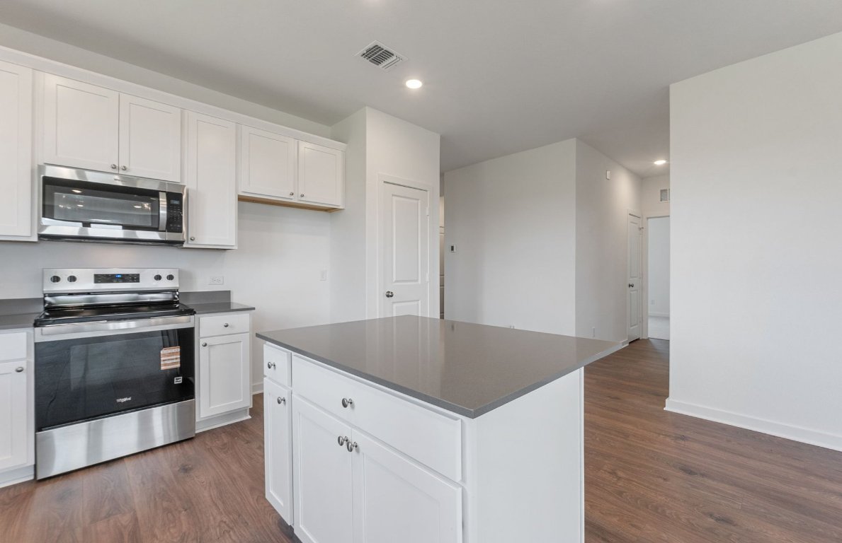 3003 Gillespie Court Temple, TX 76501 - Photo 4 of 17 a kitchen with granite countertop a stove and a sink