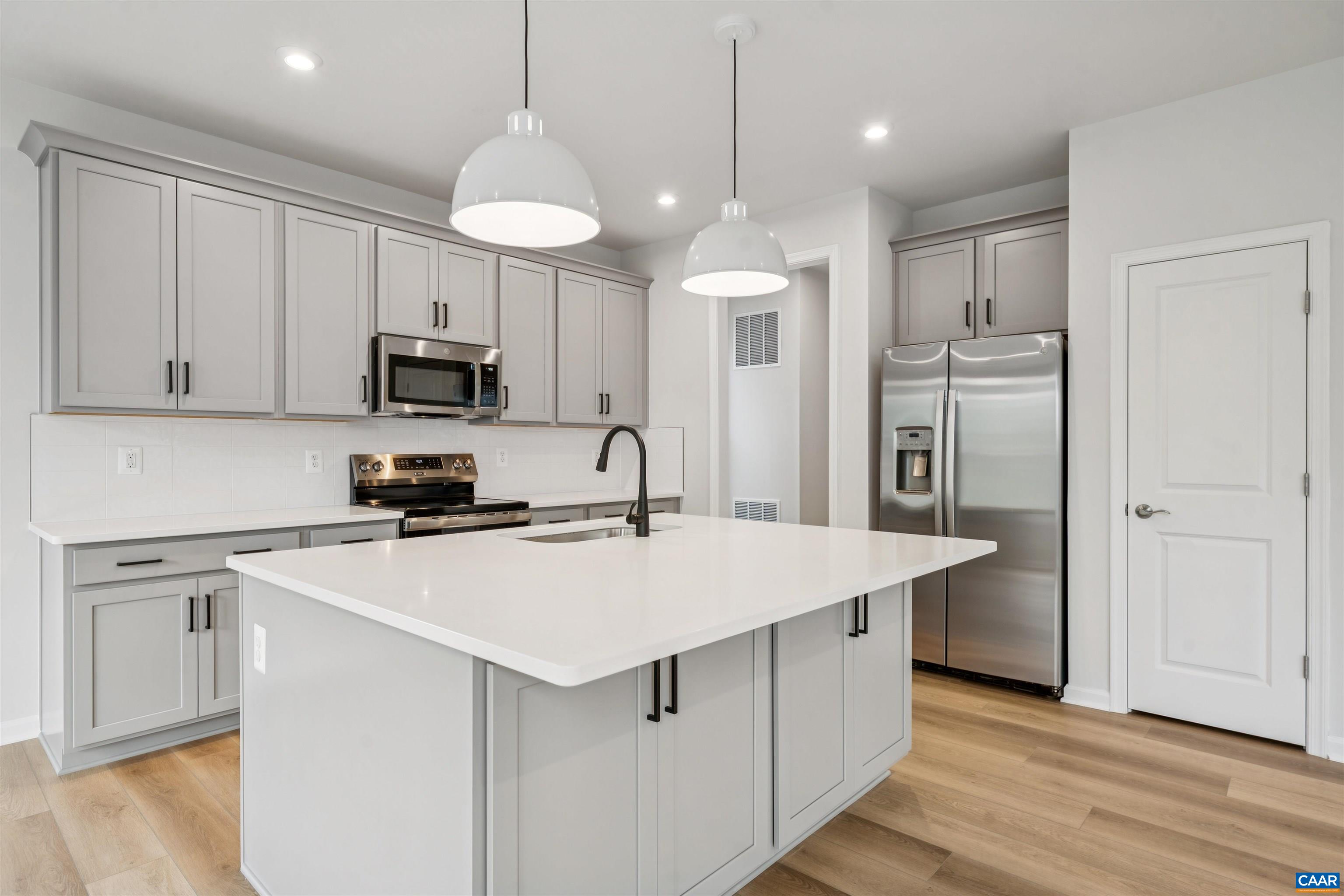 3035 Rambling Brk Lane Crozet, VA 22932 - Photo 11 of 45 a kitchen with kitchen island a white cabinets and refrigerator
