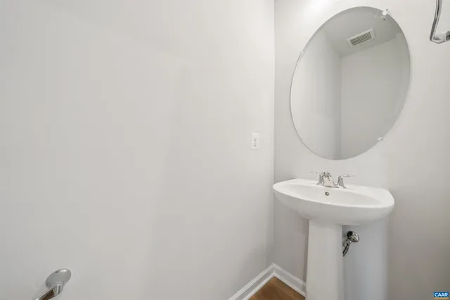 a bathroom with a sink and mirror