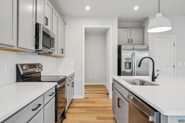 a kitchen with stainless steel appliances granite countertop a sink and a stove