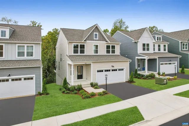 a view of house with yard and green space