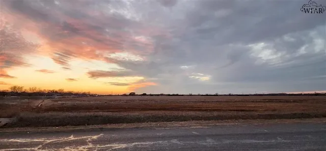 a view of a pathway both side of grassy field