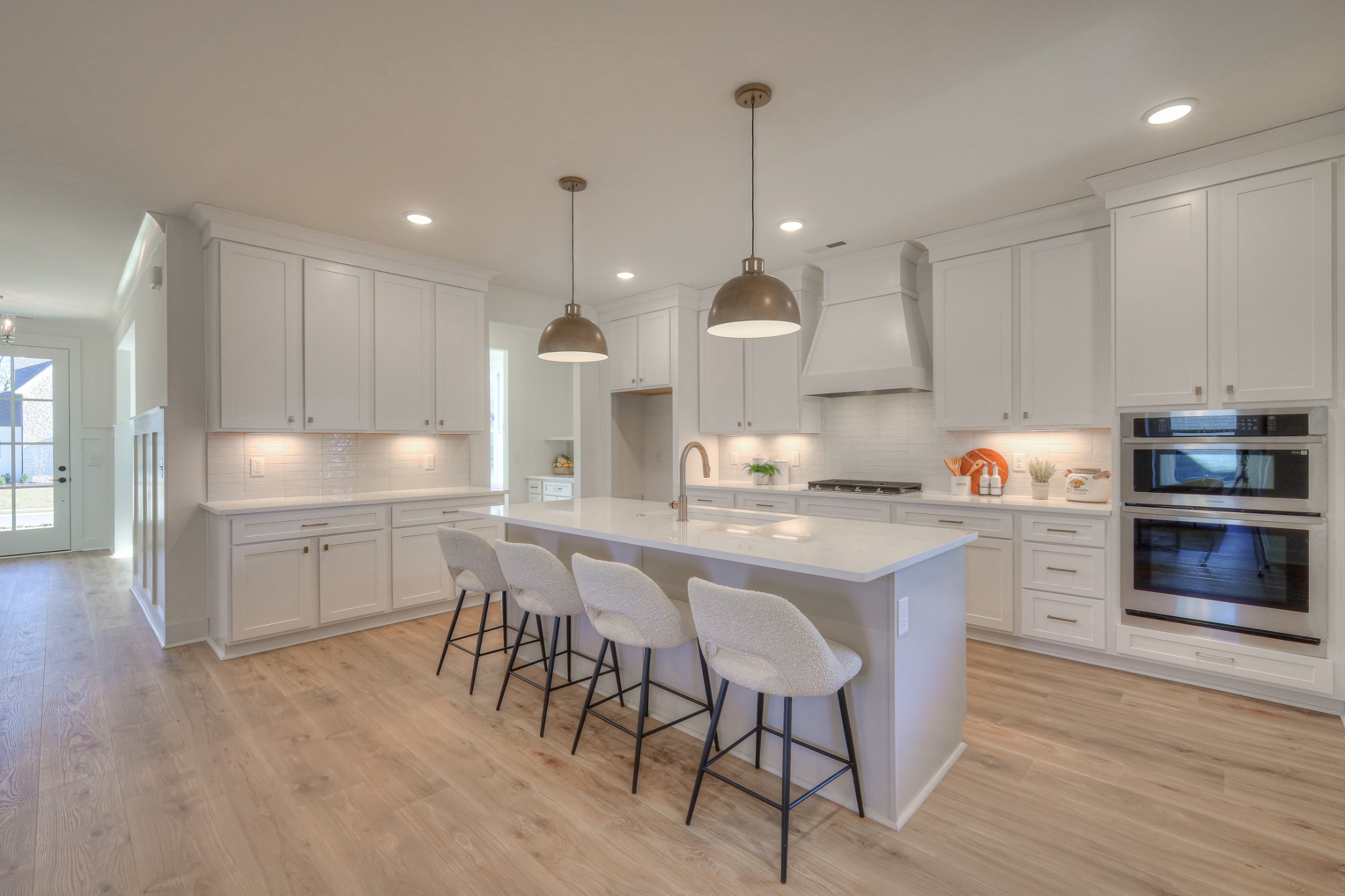 a kitchen with kitchen island granite countertop a sink a counter space stainless steel appliances and cabinets