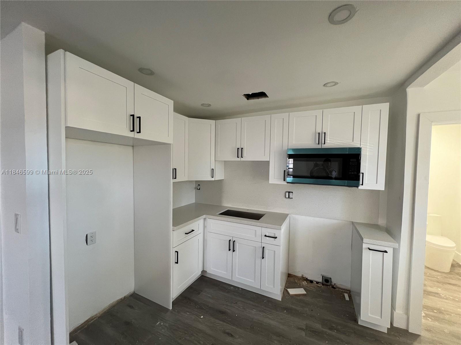 1800 Southwest 3rd Street Miami, FL 33135 - Photo 2 of 17 a kitchen with stainless steel appliances white cabinets and a sink