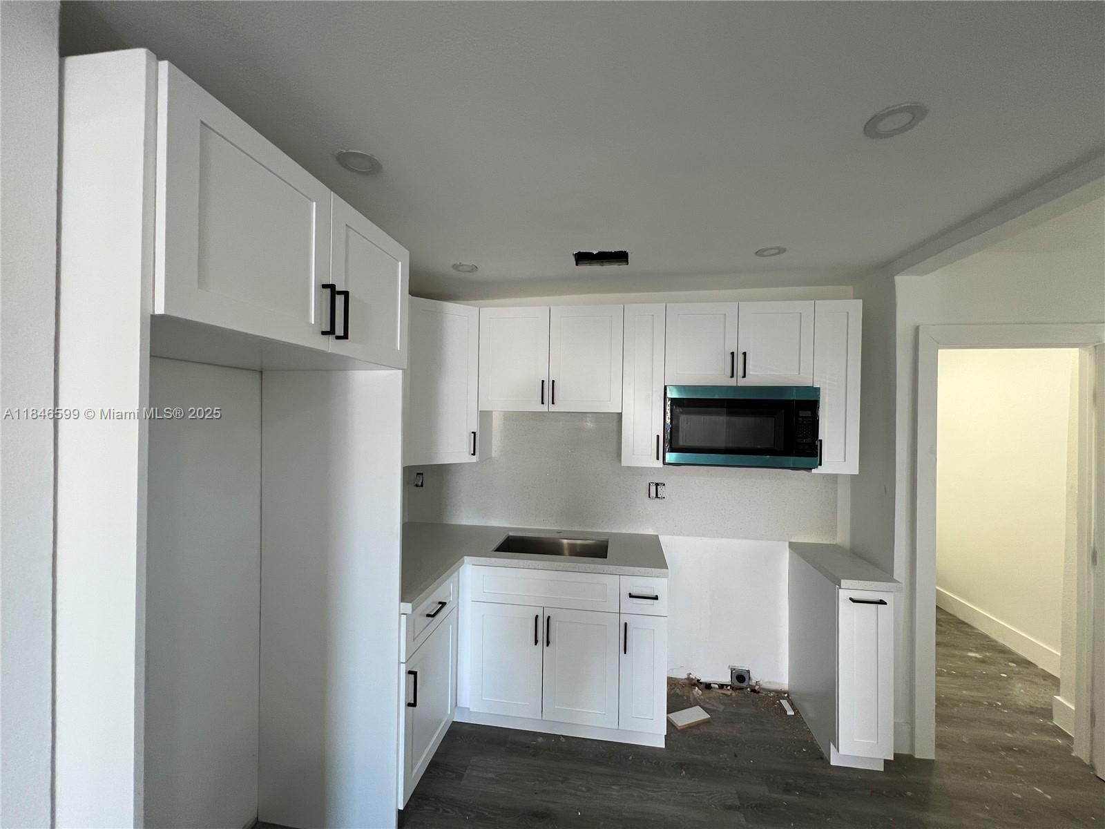 1800 Southwest 3rd Street Miami, FL 33135 - Photo 4 of 17 a kitchen with a refrigerator stove and white cabinets