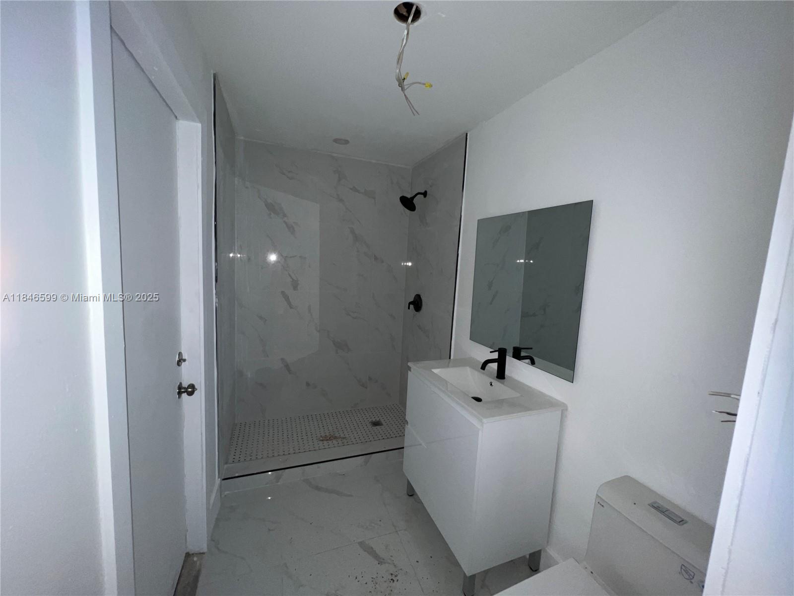 1800 Southwest 3rd Street Miami, FL 33135 - Photo 5 of 17 a bathroom with a sink a toilet and shower