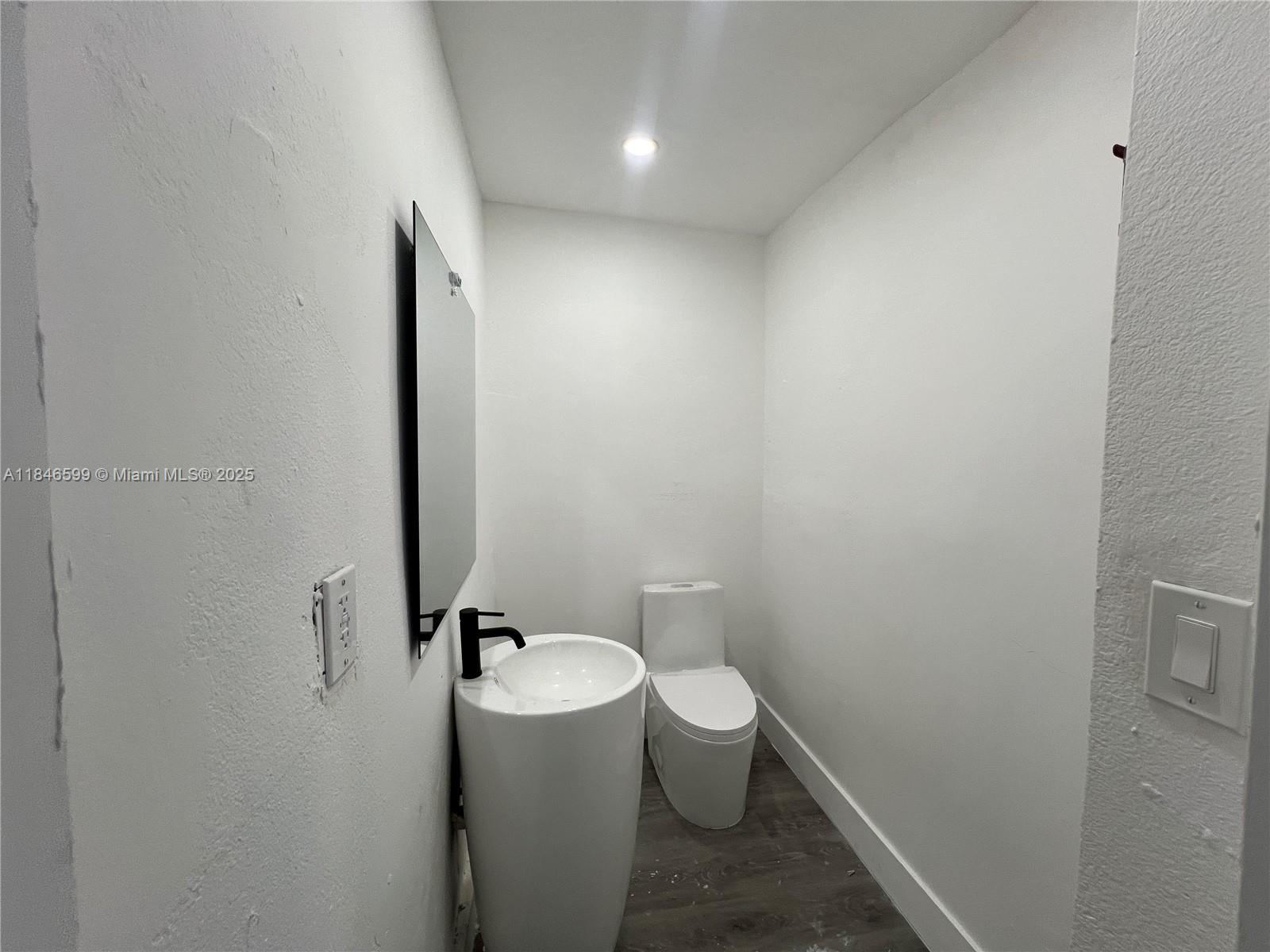 1800 Southwest 3rd Street Miami, FL 33135 - Photo 6 of 17 a bathroom with a granite countertop toilet and a sink