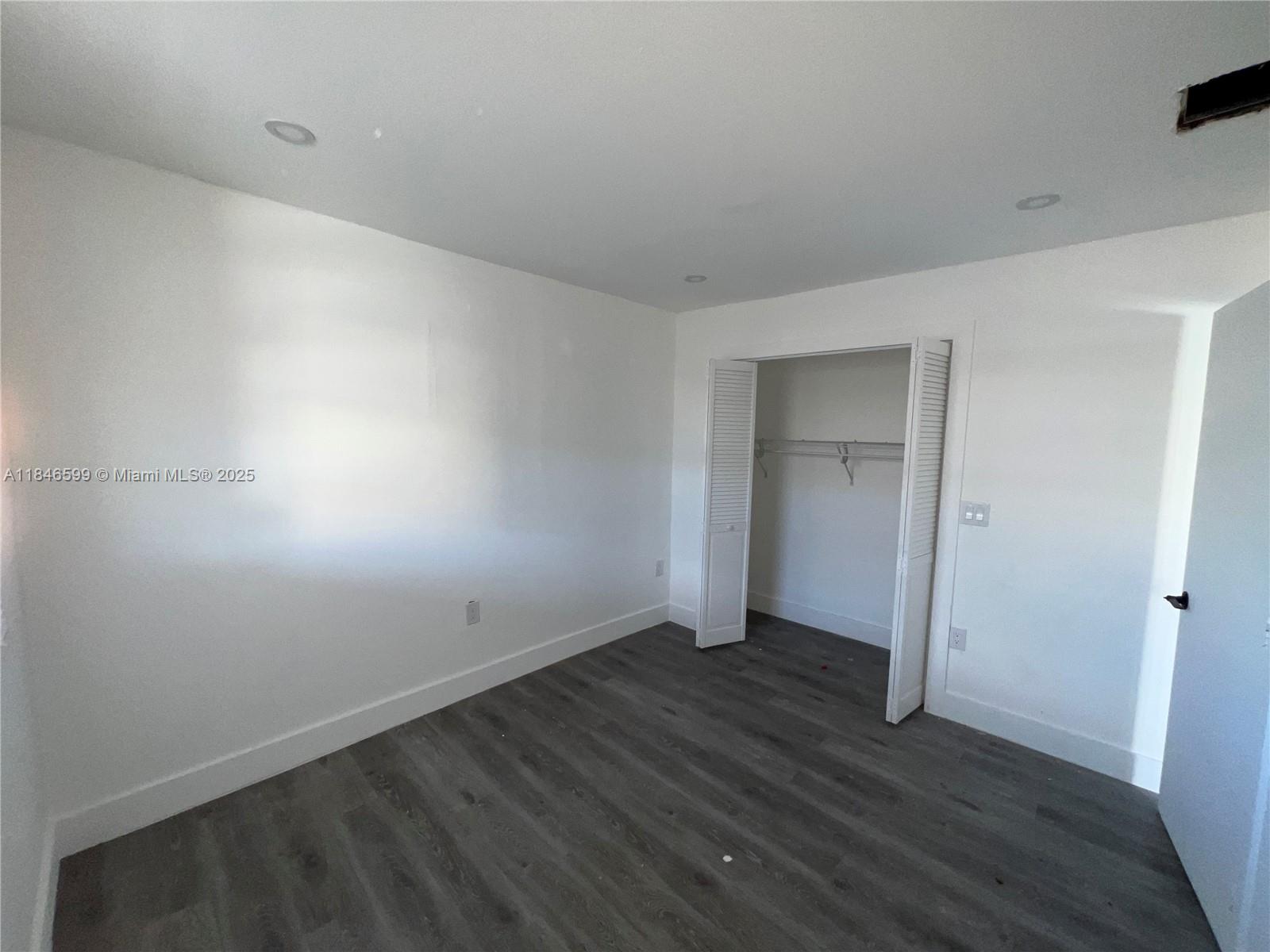 1800 Southwest 3rd Street Miami, FL 33135 - Photo 10 of 17 a view of an empty room with wooden floor and closet