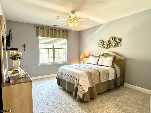 a spacious bedroom with a bed and a chandelier