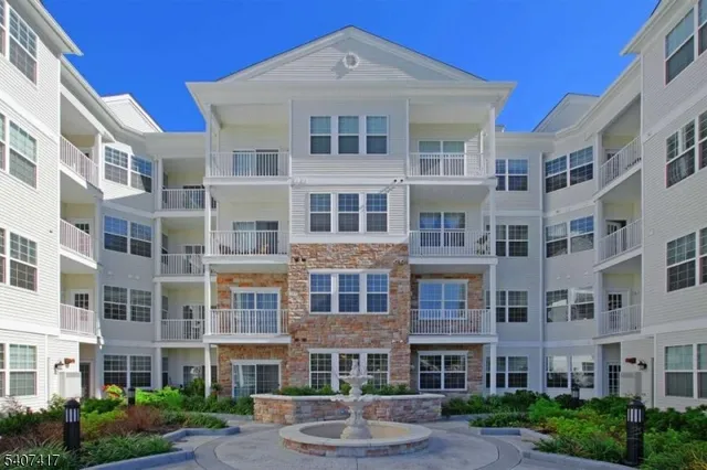 a front view of a building with a yard