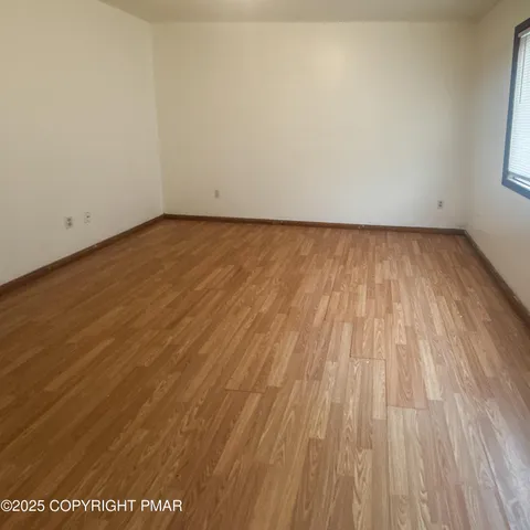 a view of room with wooden floor