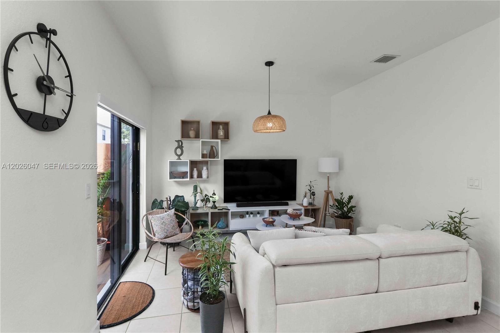 12862 Southwest 231st Street Miami, FL 33170 - Photo 10 of 30 a living room with furniture a flat screen tv and a wall painting