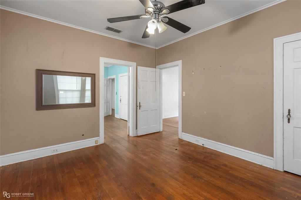 117 Merrick Street Shreveport, LA 71104 - Photo 22 of 25 a view of an empty room with window and wooden floor