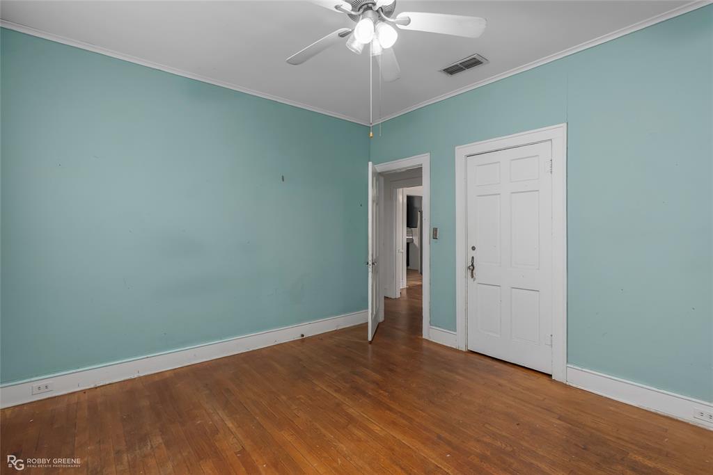 117 Merrick Street Shreveport, LA 71104 - Photo 24 of 25 an empty room with wooden floor fan and windows