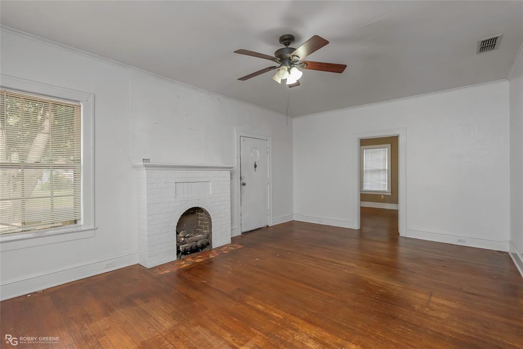 117 Merrick Street Shreveport, LA 71104 - Photo 8 of 25 a view of a livingroom with a fireplace window and wooden floor