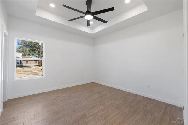 a view of an empty room with a window and closet