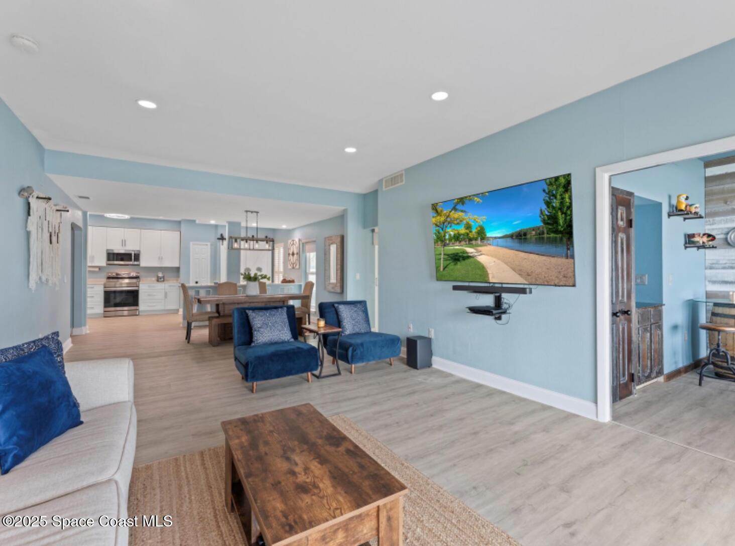 3037 S Highway, Unit 2C Melbourne Beach, FL 32951 - Photo 12 of 48 a living room with furniture and a flat screen tv