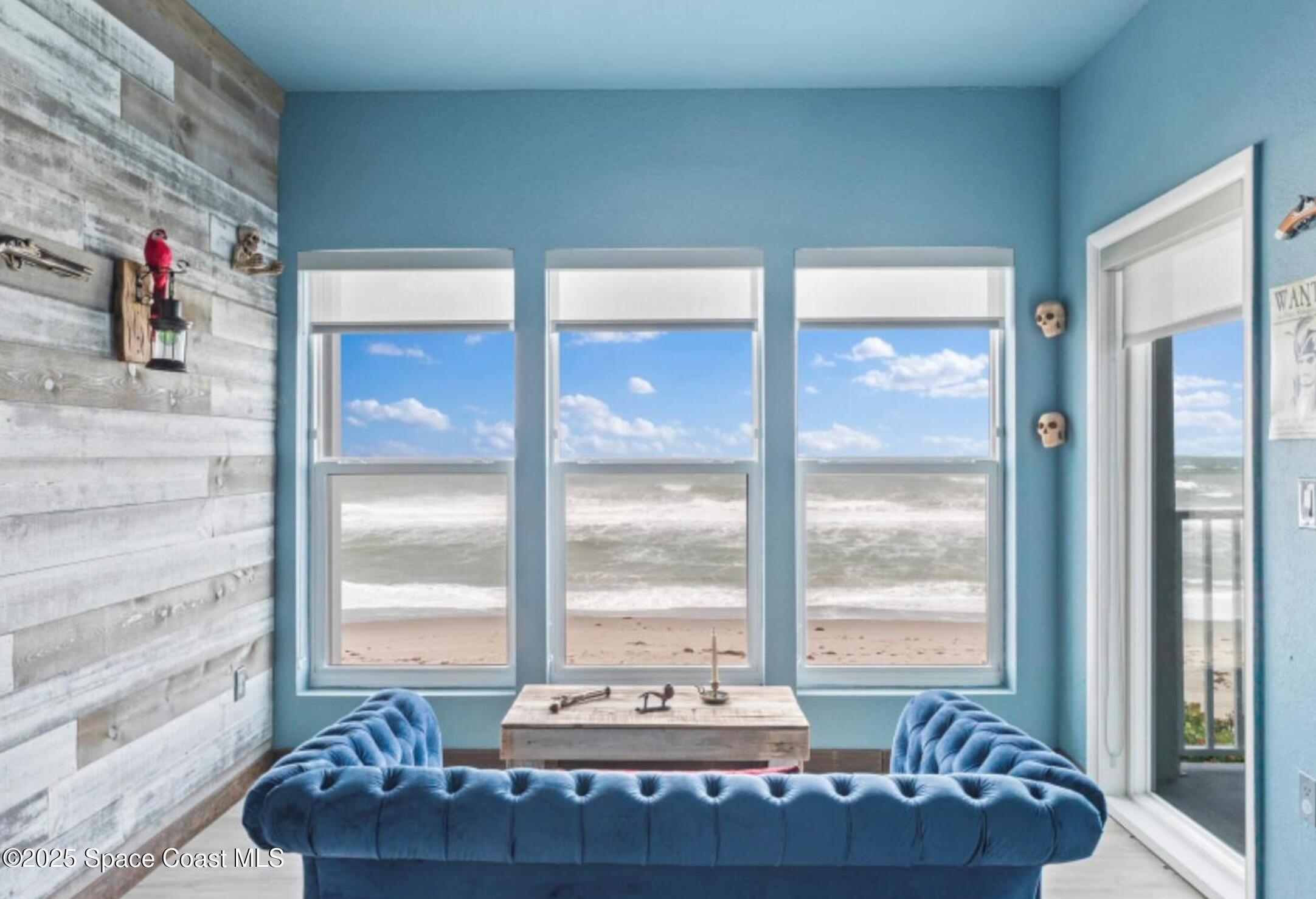 3037 S Highway, Unit 2C Melbourne Beach, FL 32951 - Photo 15 of 48 a view of a living room with a floor to ceiling window and floor