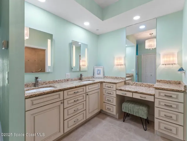 a spacious bathroom with a granite countertop sink a toilet and a mirror