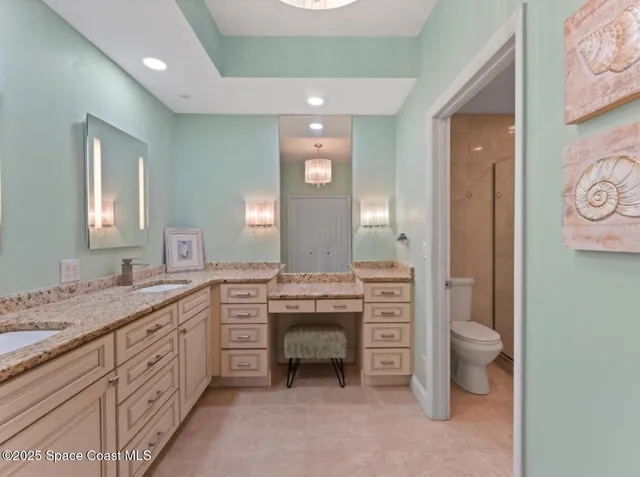 a bathroom with a shower a toilet and a sink