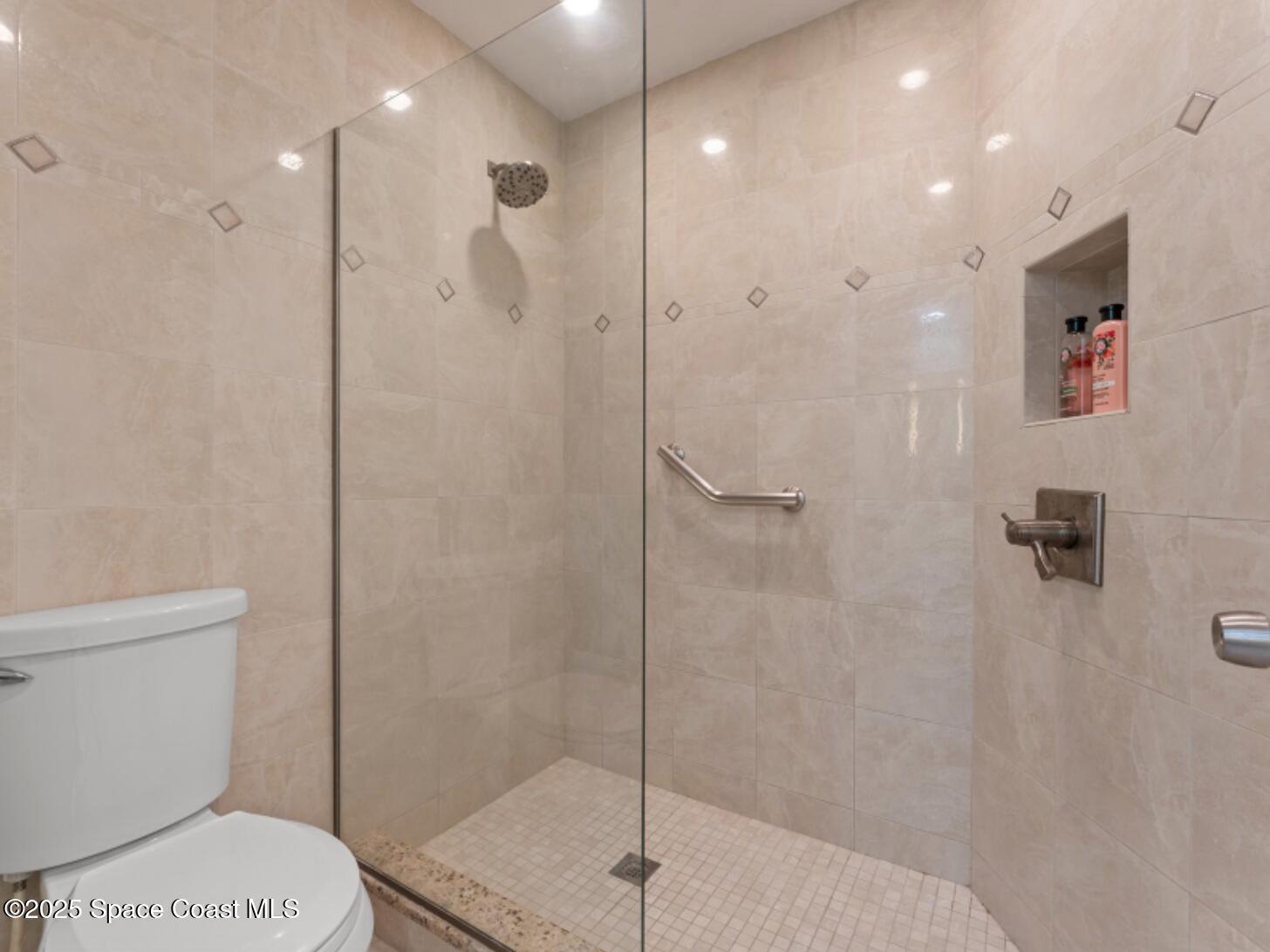 3037 S Highway, Unit 2C Melbourne Beach, FL 32951 - Photo 21 of 48 a bathroom with a shower a toilet and a sink