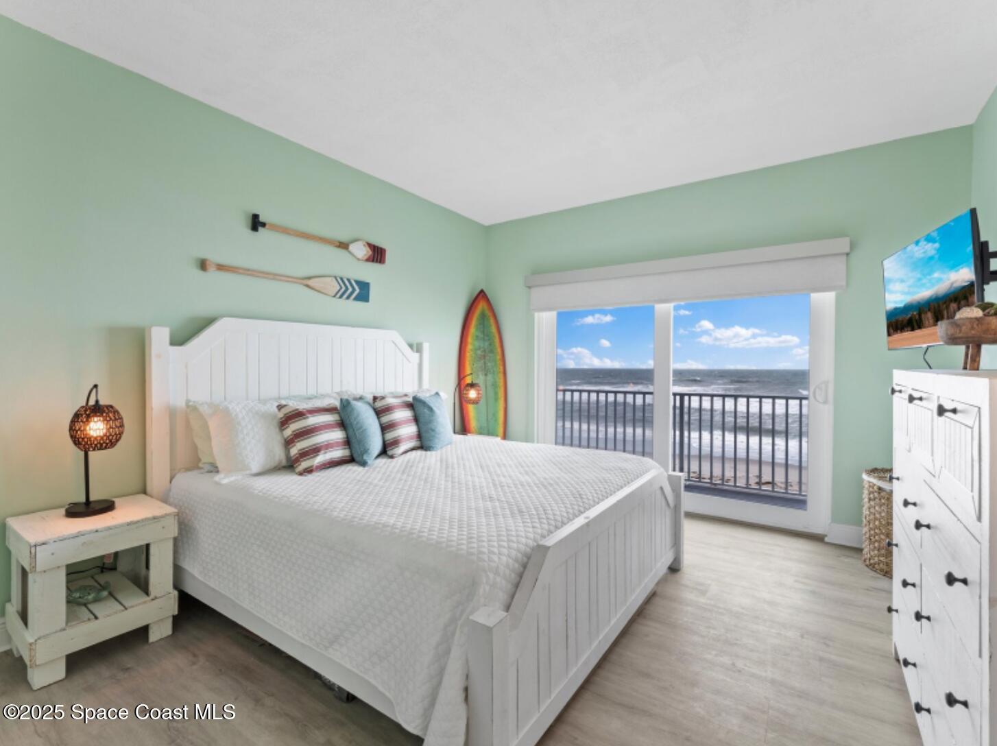 3037 S Highway, Unit 2C Melbourne Beach, FL 32951 - Photo 22 of 48 a bedroom with a bed a window and dresser