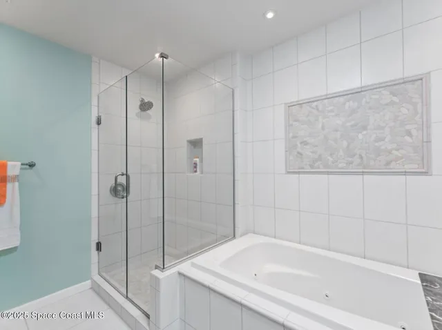 a bathroom with a tub sink and mirror