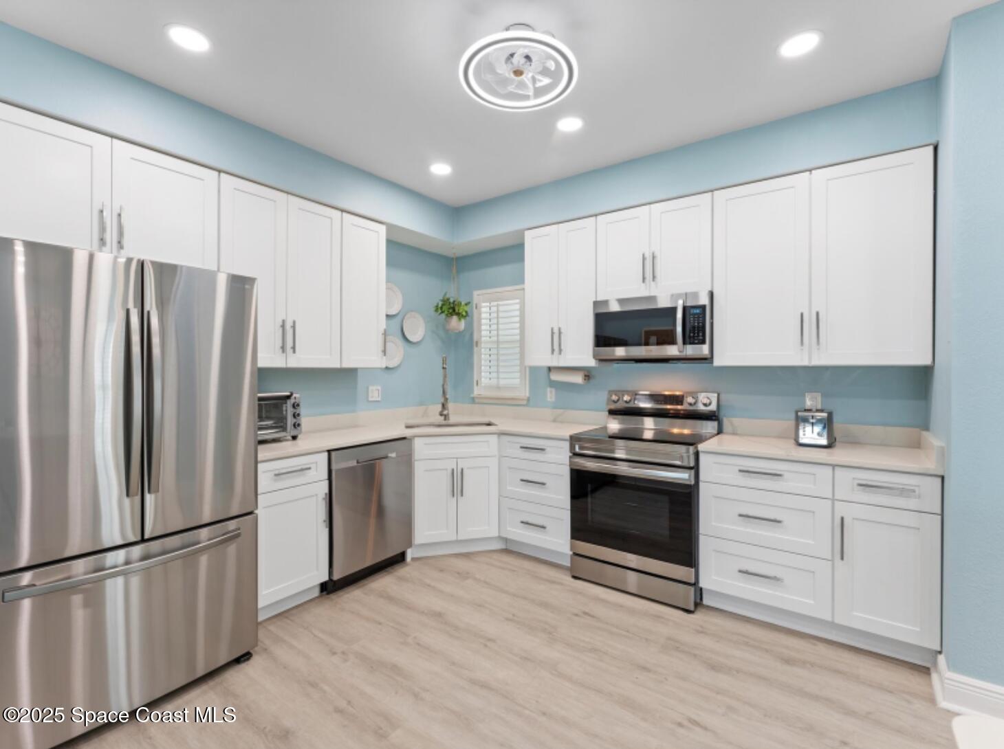 3037 S Highway, Unit 2C Melbourne Beach, FL 32951 - Photo 3 of 48 a kitchen with stainless steel appliances granite countertop a stove a sink and a refrigerator