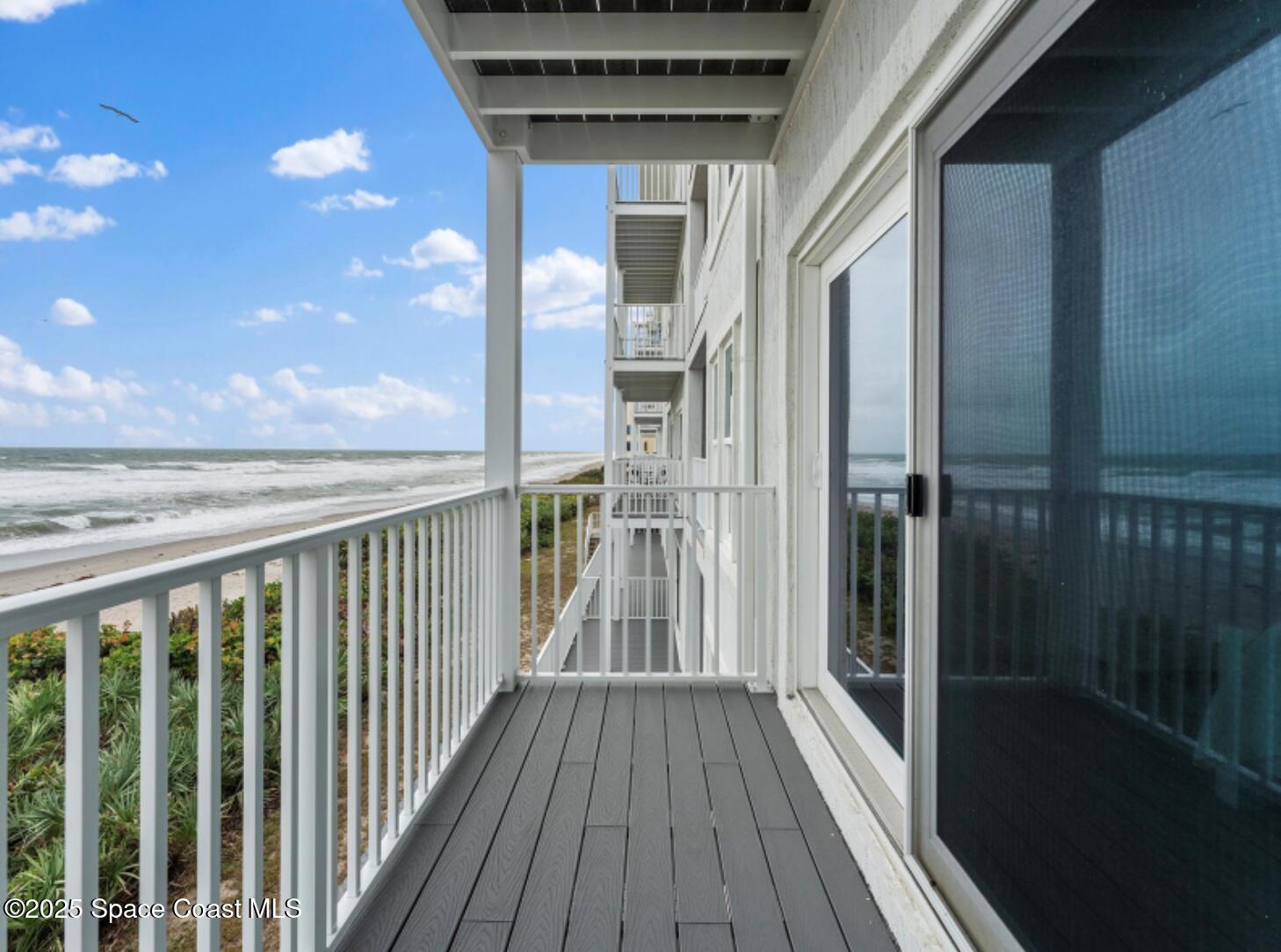 3037 S Highway, Unit 2C Melbourne Beach, FL 32951 - Photo 31 of 48 a view of a balcony with wooden floor