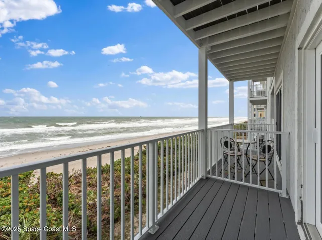 a view of a balcony with wooden floor