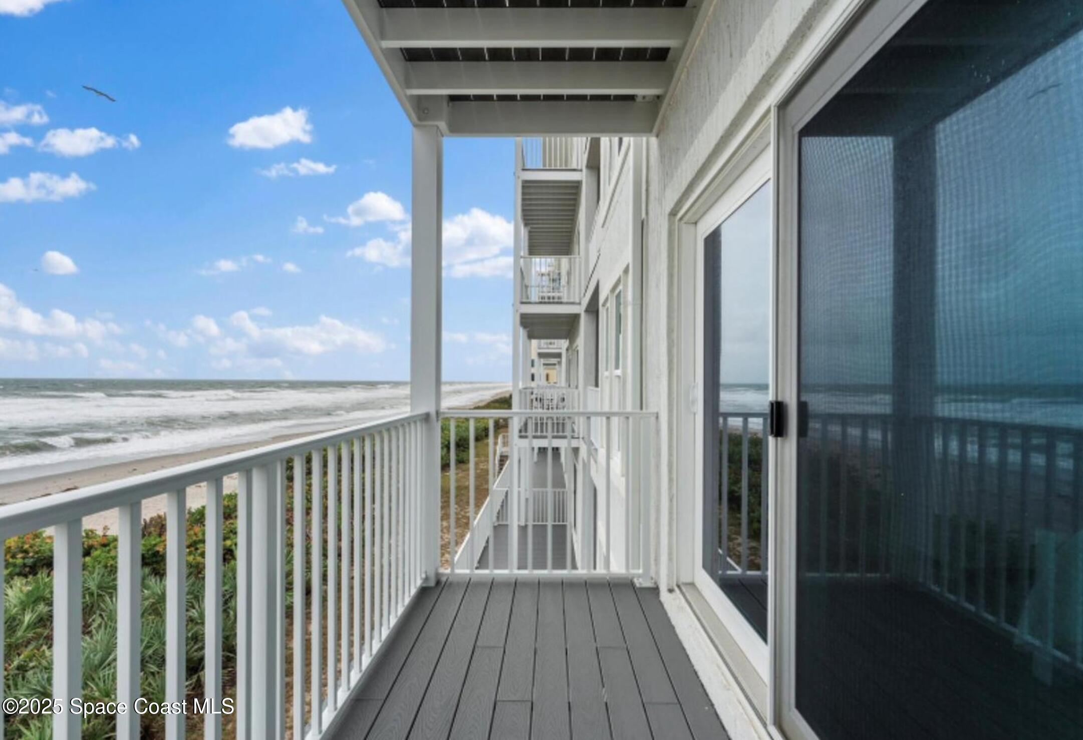 3037 S Highway, Unit 2C Melbourne Beach, FL 32951 - Photo 33 of 48 a view of a balcony with wooden floor