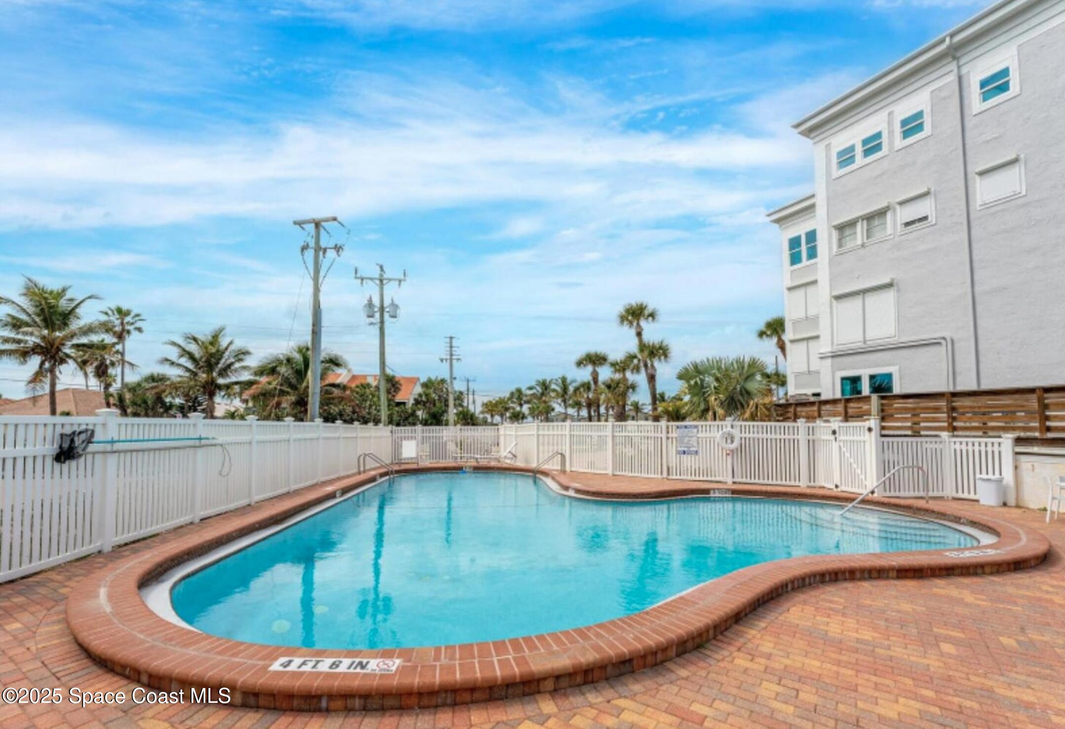 3037 S Highway, Unit 2C Melbourne Beach, FL 32951 - Photo 35 of 48 a view of a swimming pool with a lounge chair