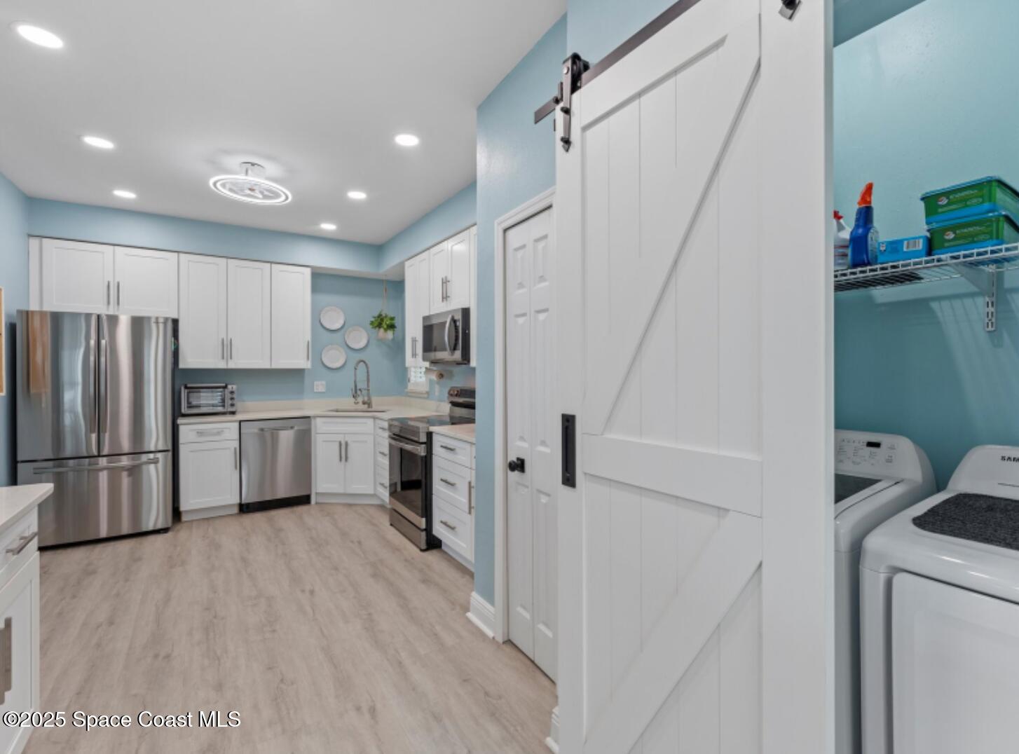 3037 S Highway, Unit 2C Melbourne Beach, FL 32951 - Photo 6 of 48 a kitchen with a refrigerator a sink and dishwasher