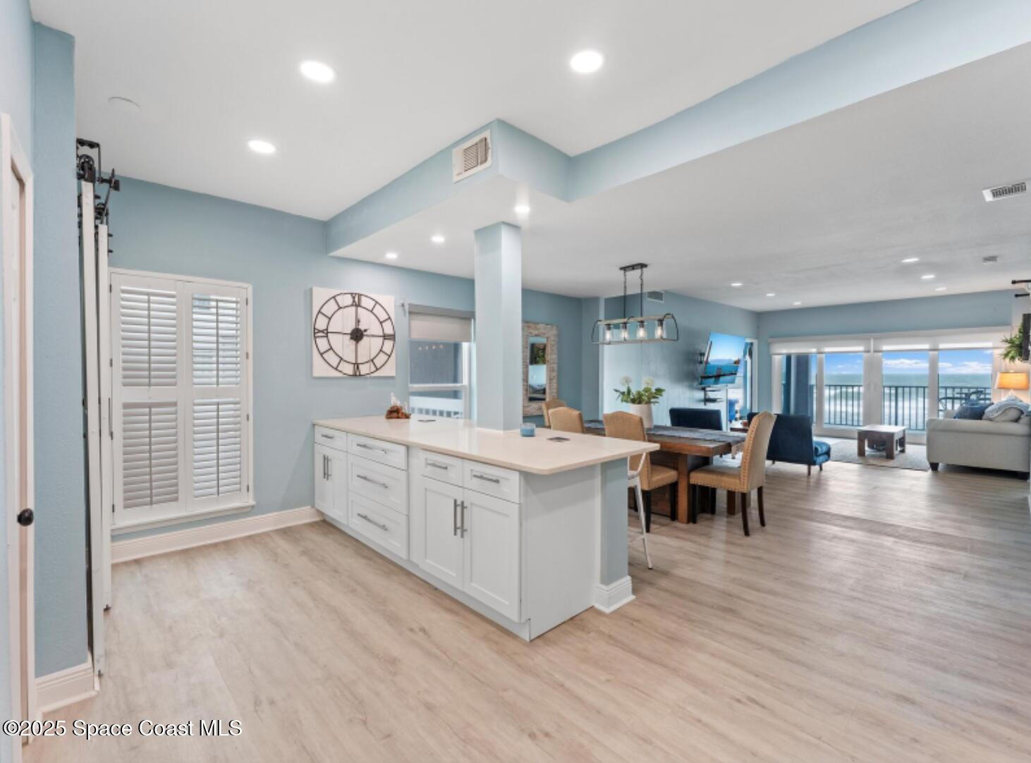 3037 S Highway, Unit 2C Melbourne Beach, FL 32951 - Photo 7 of 48 a large white kitchen with lots of counter space