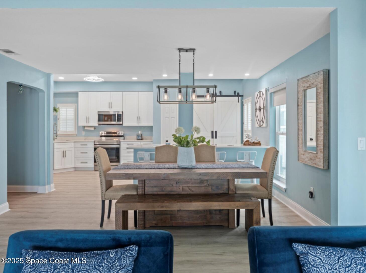 3037 S Highway, Unit 2C Melbourne Beach, FL 32951 - Photo 10 of 48 a view of a dining room with furniture and wooden floor