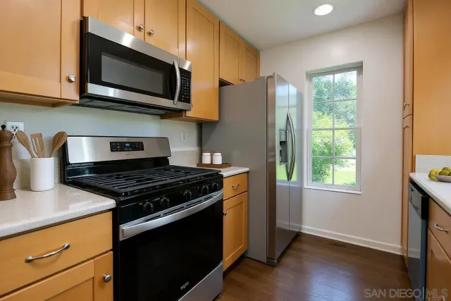 a kitchen with granite countertop a sink and a window