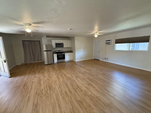 a view of a kitchen with a sink cabinets and wooden floor