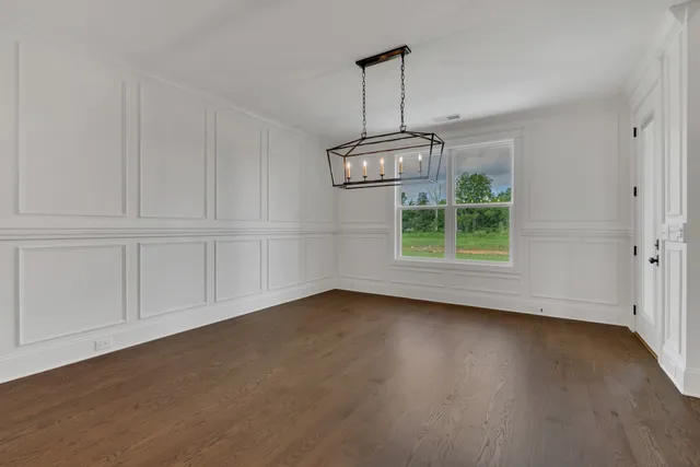 a view of a kitchen with furniture and wooden floor