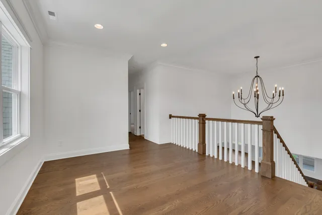 a view of an empty room with a fireplace and a window