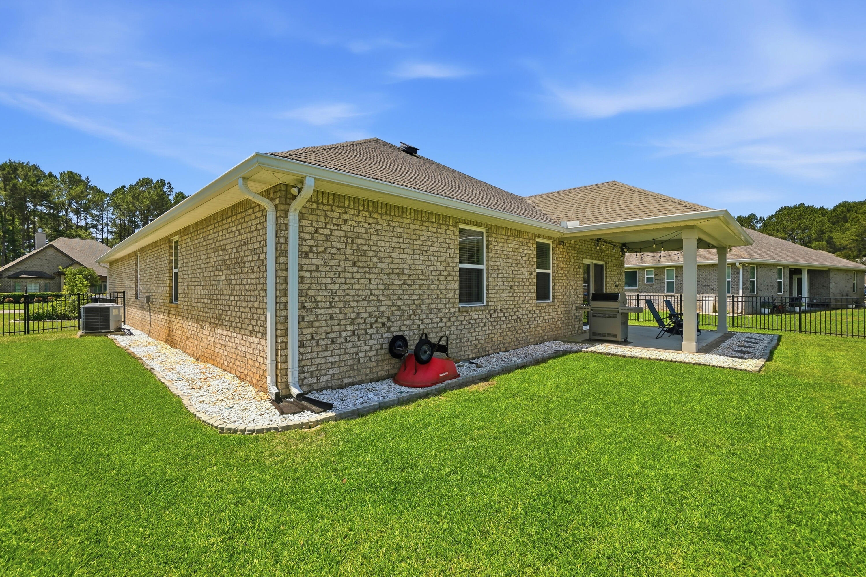 525 Windchime Way Freeport, FL 32439 - Photo 33 of 59 a front view of a house with garden
