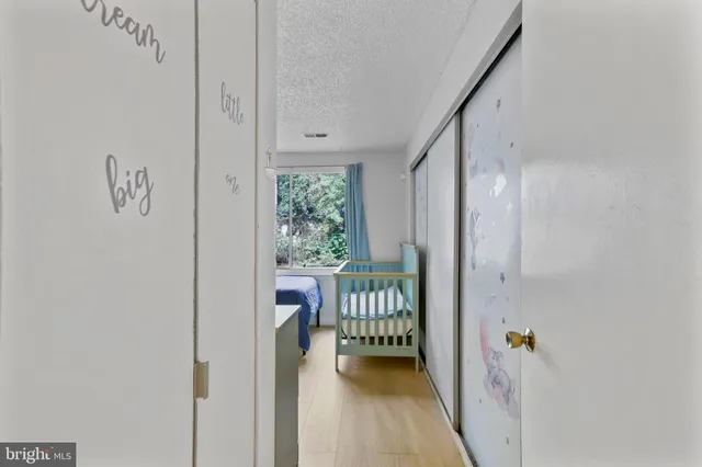 a view of a hallway with a door and furniture