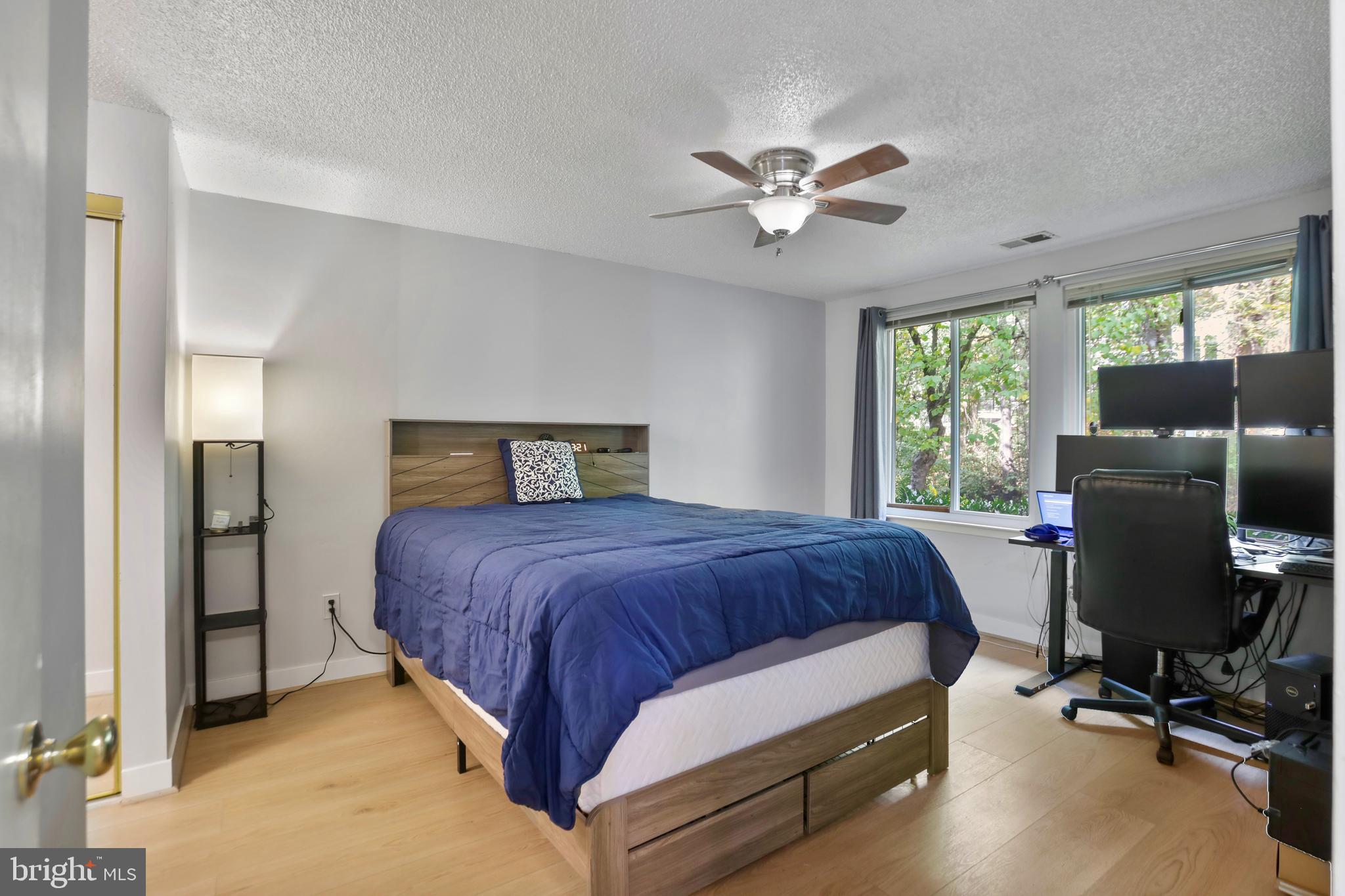 11723 Summerchase Circle Reston, VA 20194 - Photo 16 of 22 a bedroom with a bed and a chandelier