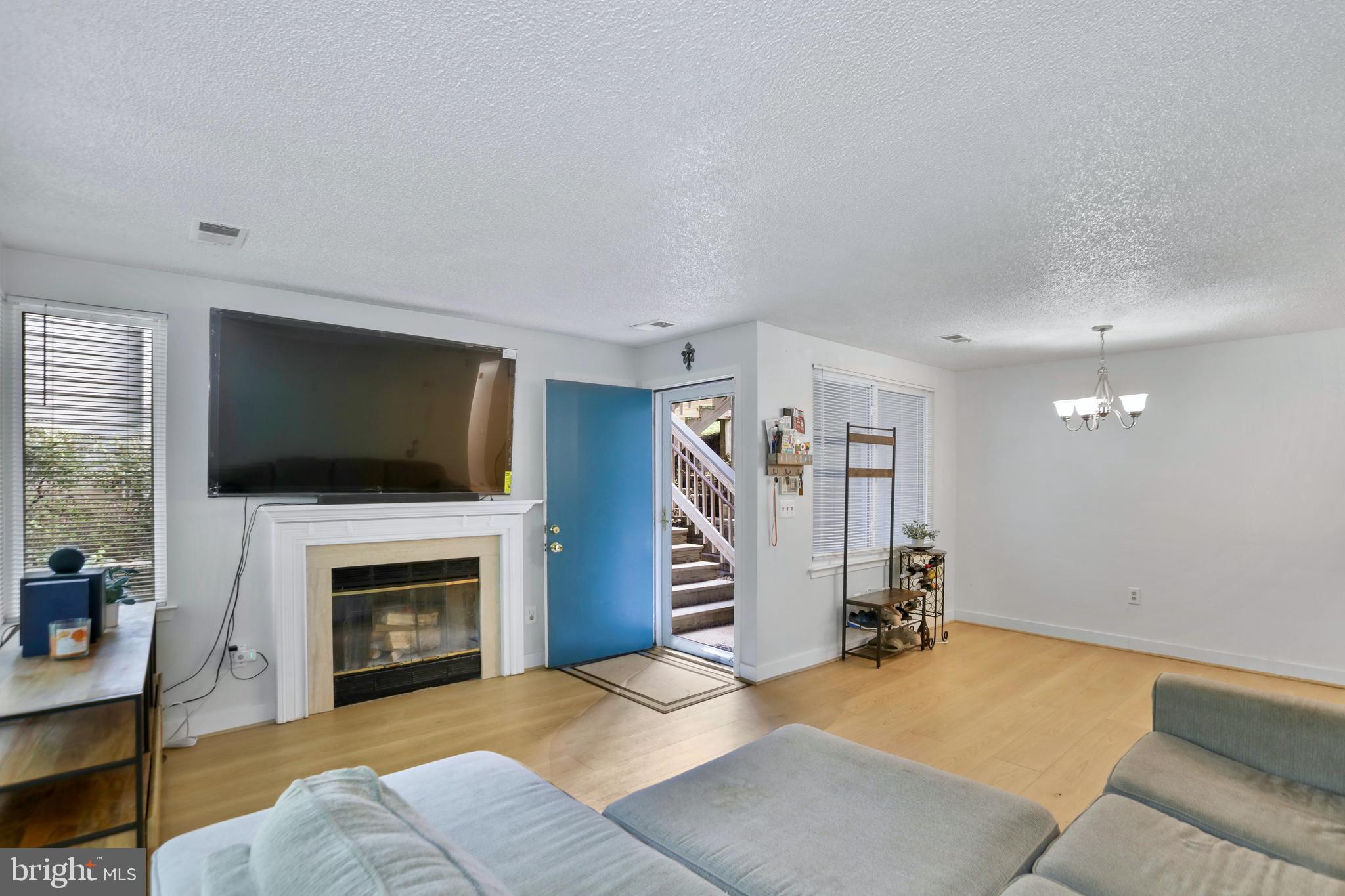 11723 Summerchase Circle Reston, VA 20194 - Photo 5 of 22 a living room with furniture and a flat screen tv